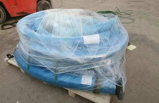 Flanged fuel oil suction and discharge rubber hose placed on a wooden pallet after packaging