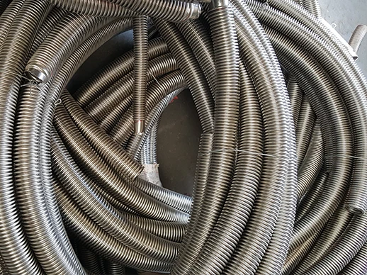 A roll of metal hose with a corrugated outer layer
