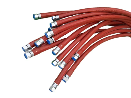 Multiple red metal hoses with installation joints and fireproof sleeves