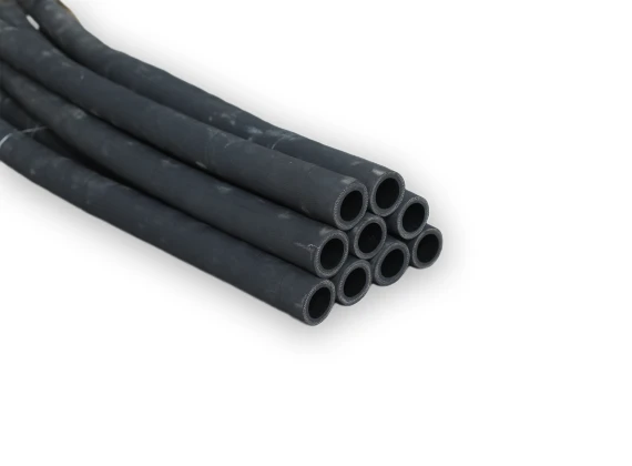 Nine black small diameter fuel oil suction and discharge rubber hoses placed together