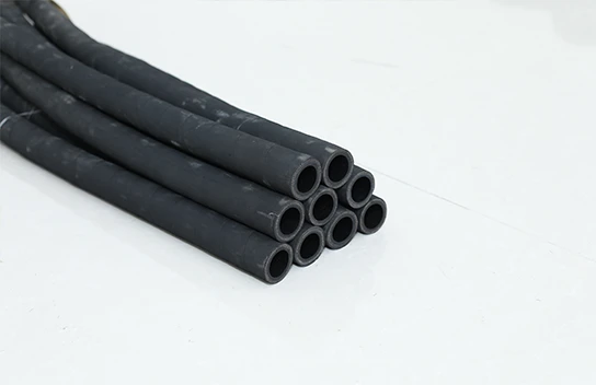 Nine black small diameter fuel oil suction and discharge rubber hoses placed together